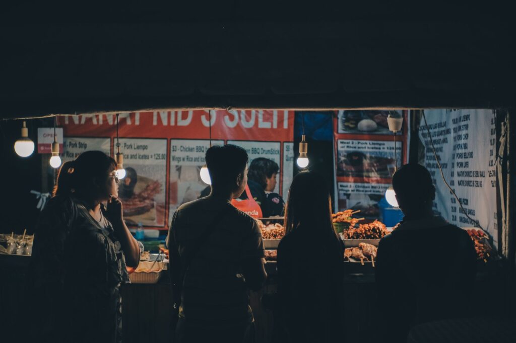 A group of tourists enjoying a food tour, sampling local delicacies under the stars. — las vegas night tours