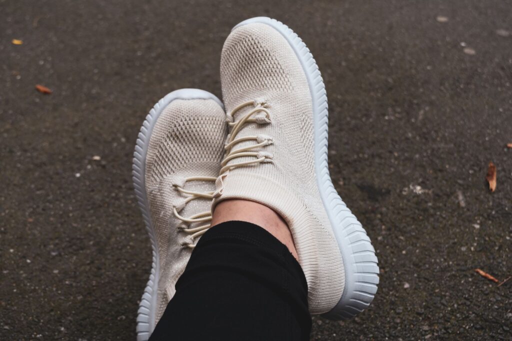 A pair of comfortable walking shoes next to a stylish outfit laid out for a day in Vegas. — packing list for Las Vegas s…