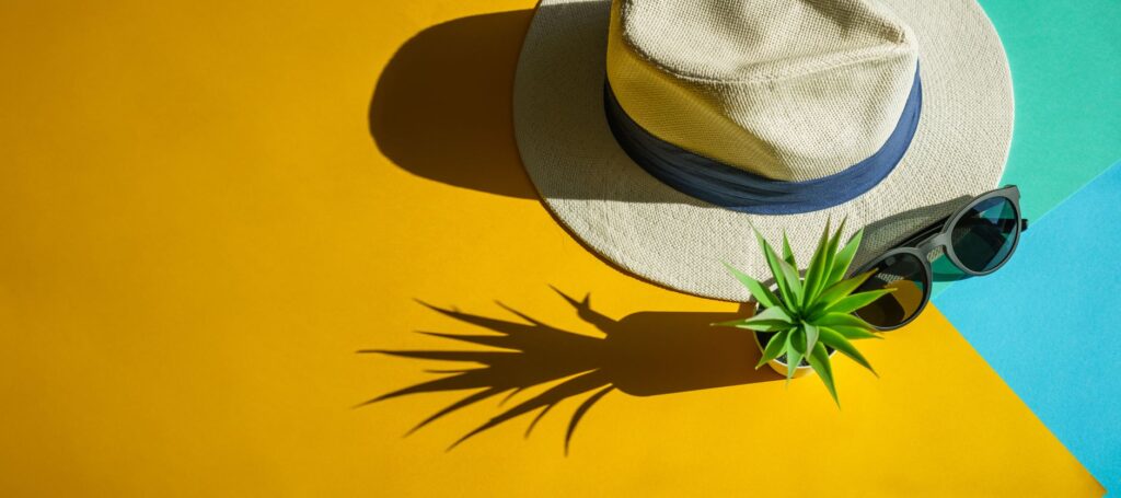 A vibrant flat lay of summer clothing essentials for Las Vegas, including light fabrics and stylish accessories. — packi…