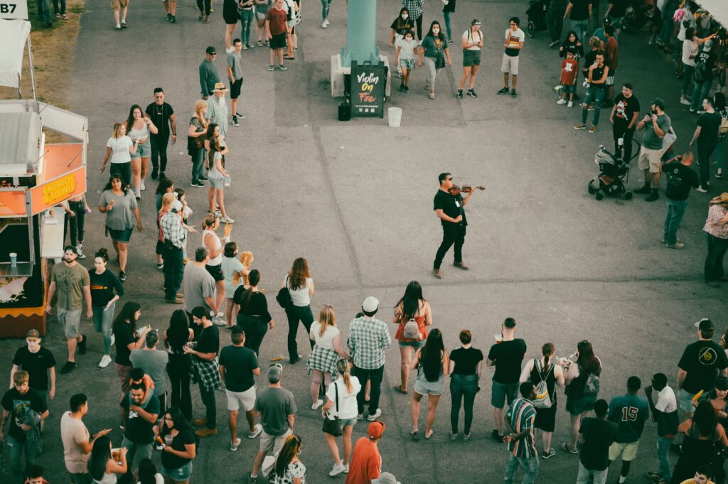 A vibrant scene from a Las Vegas summer festival, featuring food stalls and families enjoying live performances. — famil…