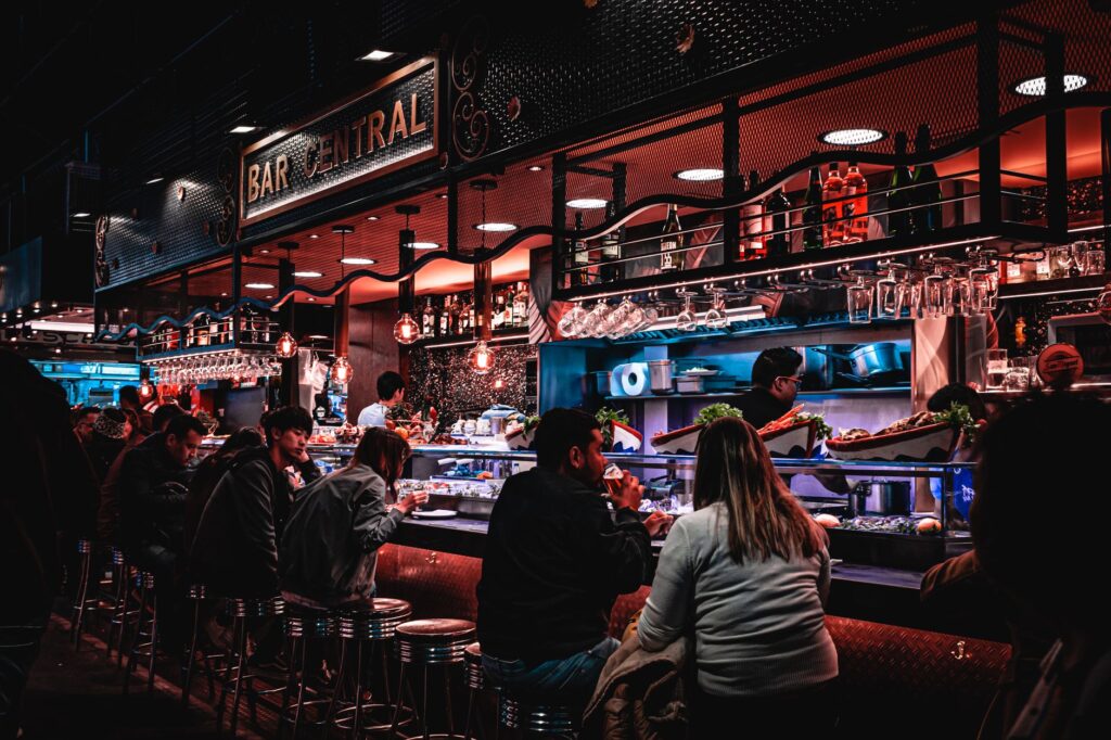 A view of a bustling local bar during happy hour, filled with patrons and a lively ambiance. — Las Vegas nightlife tips