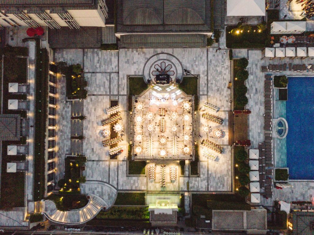 An aerial view of a bustling pool party at a luxury resort, capturing the layout and energy of the crowd. — las vegas po…
