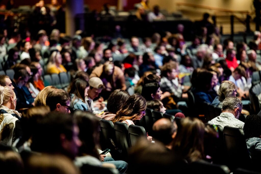 An overhead view of a Las Vegas theater filled with an enthusiastic audience. — last-minute show tickets Vegas