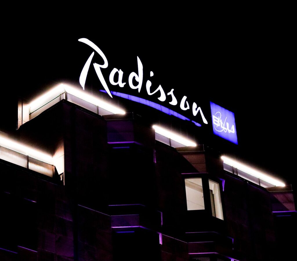Exterior view of a popular budget hotel with neon lights — budget hotels in Las Vegas