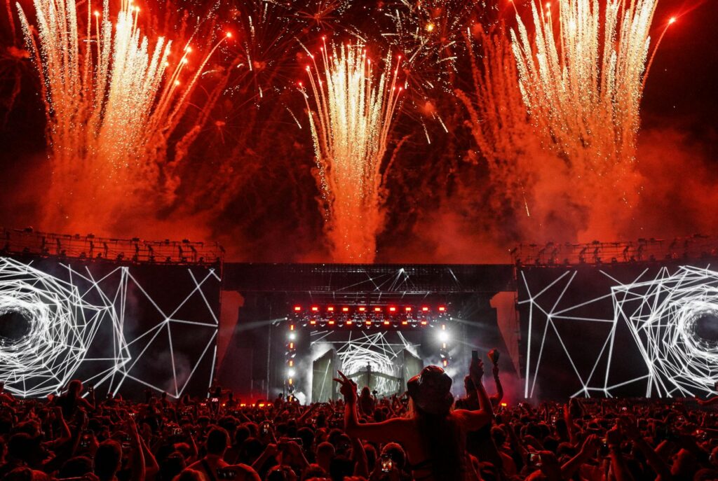 Festival-goers dancing and having fun at a popular Vegas music festival, with artists performing on stage. — Las Vegas s…
