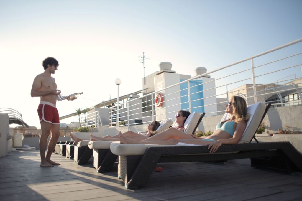 Guests lounging on cabanas with drinks in hand at a luxurious pool party. — Vegas pool parties 2026