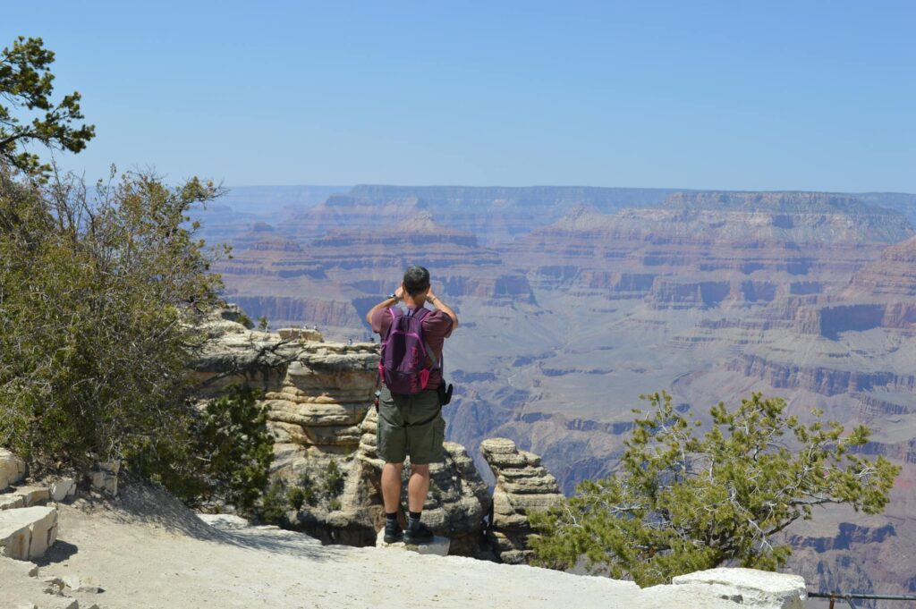 Travelers taking photos at one of the popular Grand Canyon viewpoints. — grand canyon vegas tour