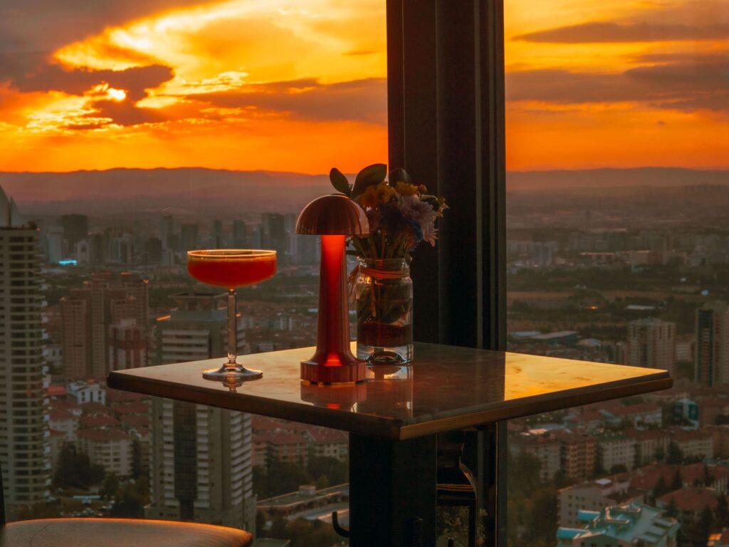 A beautifully set outdoor table at one of the rooftop bars, with twinkling lights and stunning views. — rooftop bars Las…