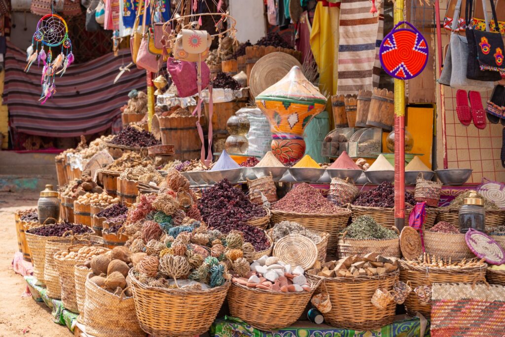 A bustling local market with a variety of vendors selling handmade goods, emphasizing the unique attractions off the Strip…