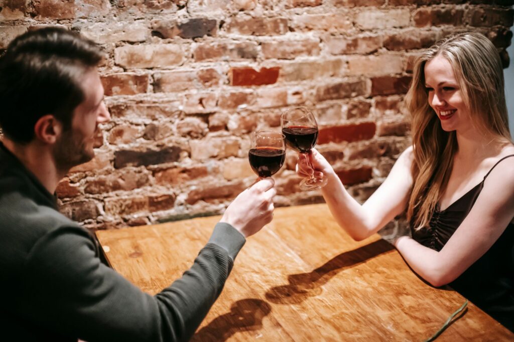 A couple enjoying a romantic dinner at a rooftop restaurant overlooking the city. — Vegas bachelor bachelorette party pl…