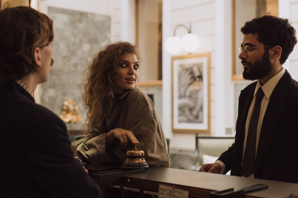 A friendly hotel receptionist assisting guests with check-in at a budget accommodation. — affordable hotels in Las Vegas
