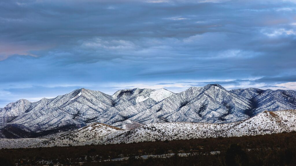 A scenic shot of Mount Charleston with snow-capped peaks against a blue sky. — scenic drives las vegas