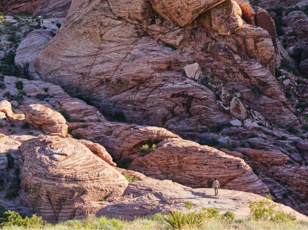 A scenic view of Red Rock Canyon with hikers — hidden gems in Las Vegas