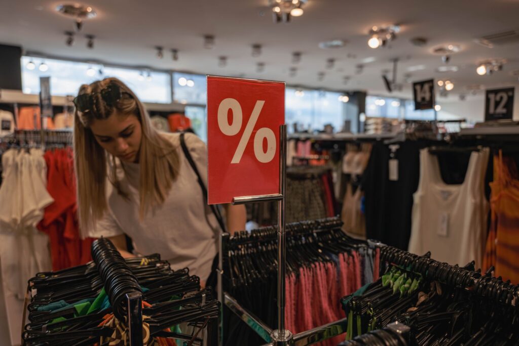 A shopper exploring an outlet mall, browsing through discounted merchandise. — cheap Vegas travel tips