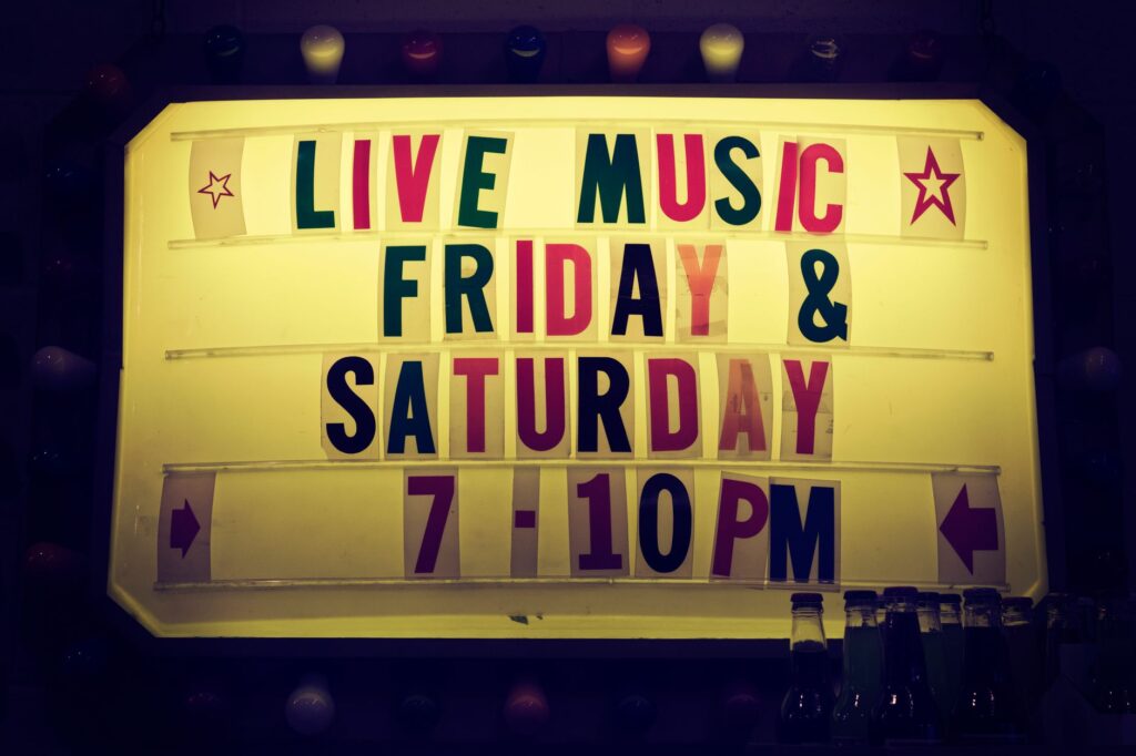 A snapshot of a nightlife venue with a promotional sign for happy hour deals. — Las Vegas nightlife budget tips