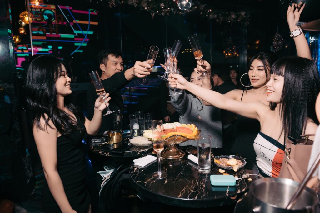 A stylish group of friends enjoying drinks at a VIP table in a Las Vegas nightclub. — Las Vegas nightclubs
