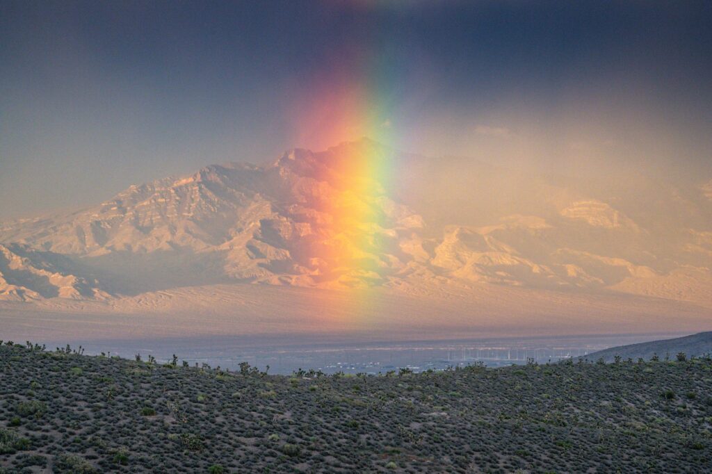 An aerial shot of Mount Charleston with the sun setting in the background, casting shadows over the mountains. — las veg…