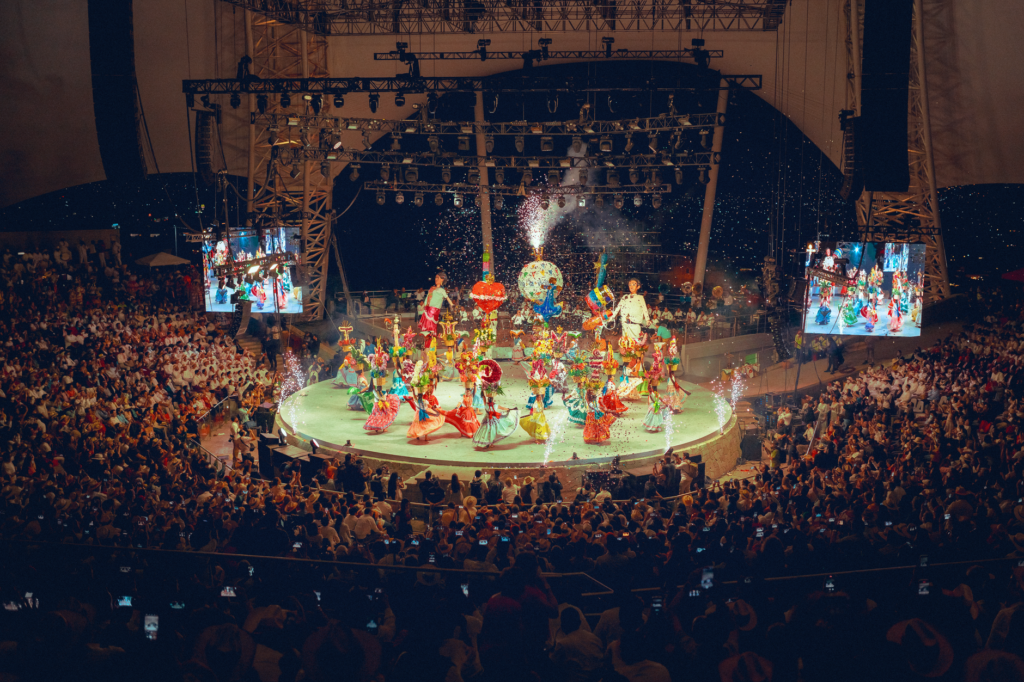 An iconic Las Vegas show with performers in vibrant costumes. — first time in Las Vegas tips
