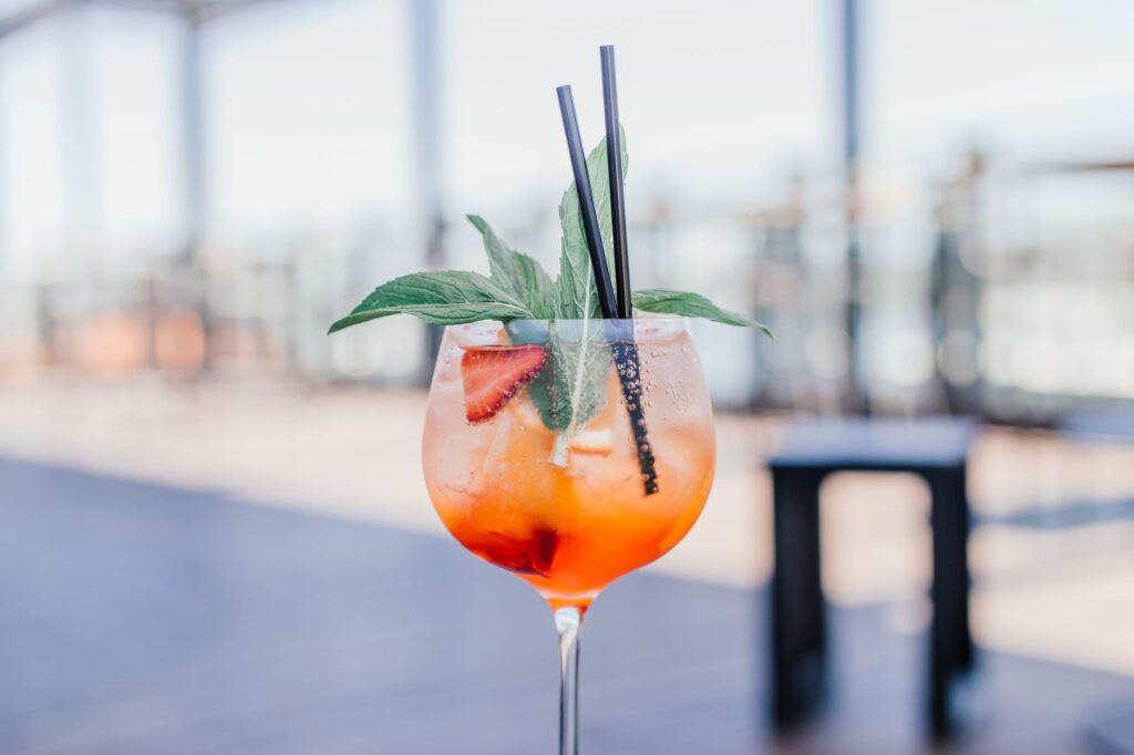 Close-up of a refreshing summer cocktail served at a rooftop bar in Vegas. — best restaurants Las Vegas summer 2026