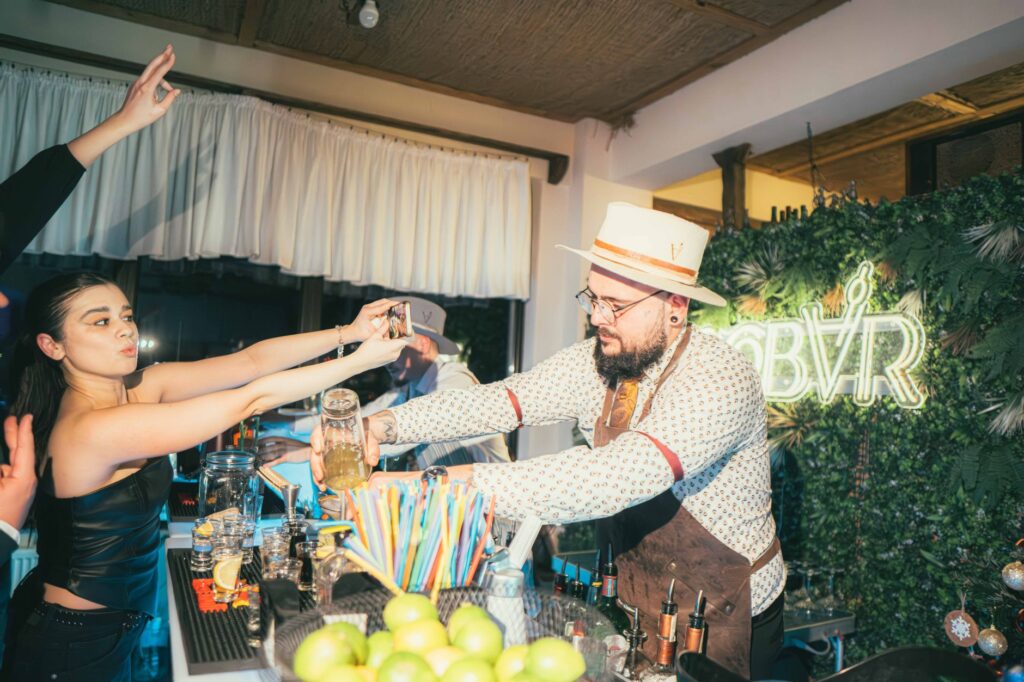 Guests enjoying cocktails at a stylish rooftop bar with city lights in the background. — rooftop bars in Las Vegas