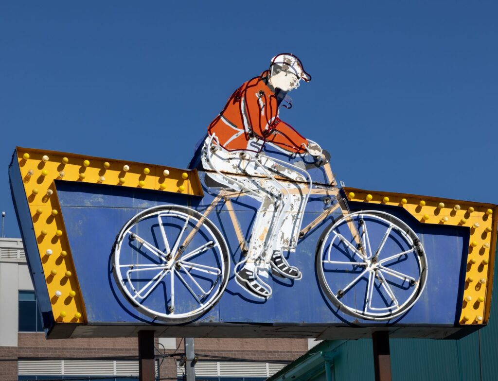 Historic neon signs displayed at the Neon Museum under a clear blue sky. — budget attractions Las Vegas