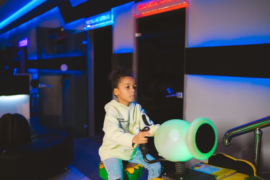 Kids playing arcade games in a fun play zone in Las Vegas. — family activities in Las Vegas