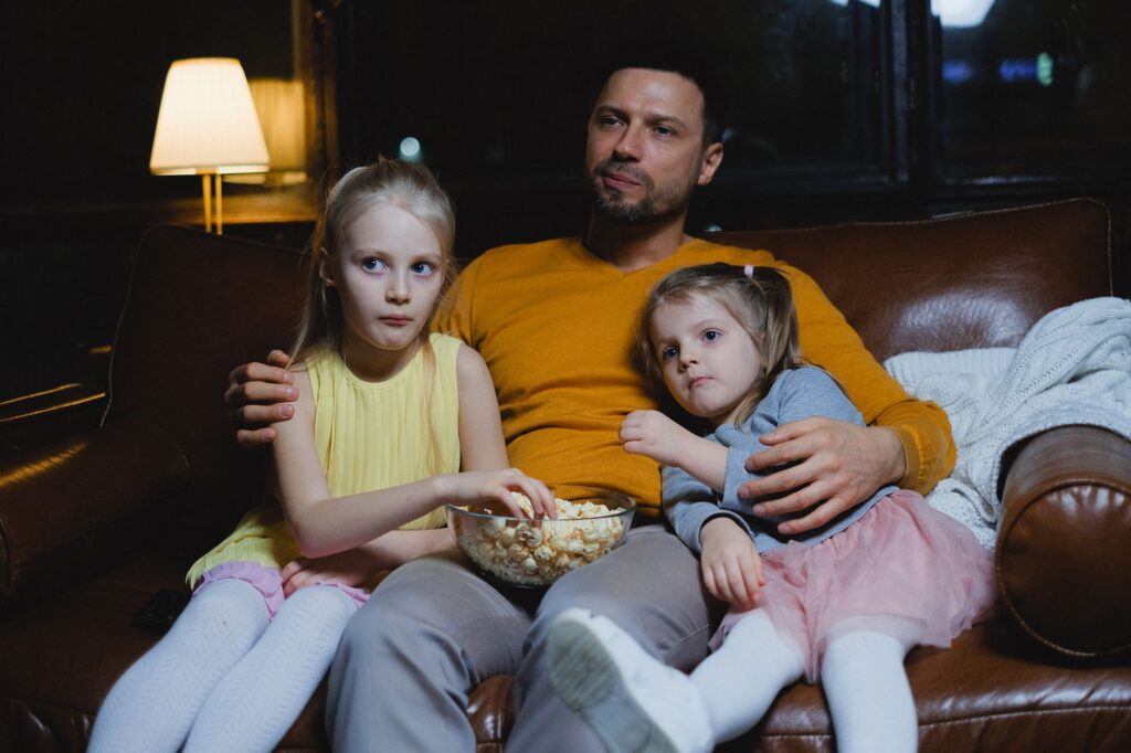 Parents and kids watching an outdoor movie at a local park. — family activities Las Vegas
