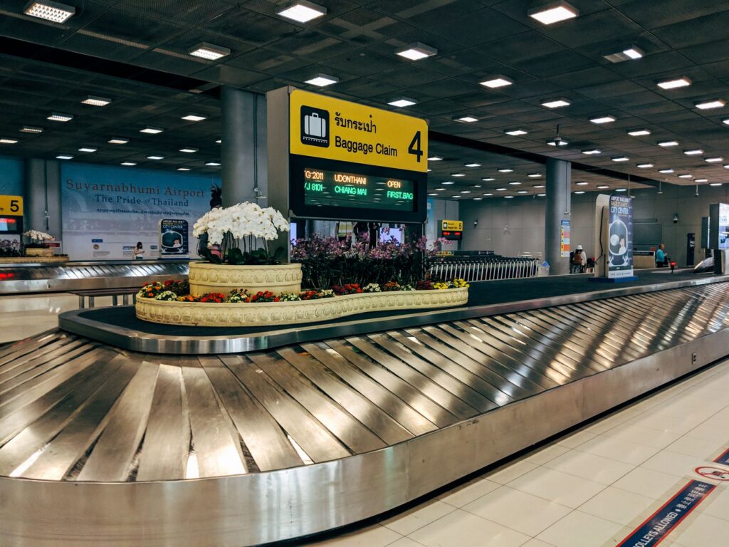 Passengers arriving at the airport with luggage at the baggage claim area. — las vegas airport guide