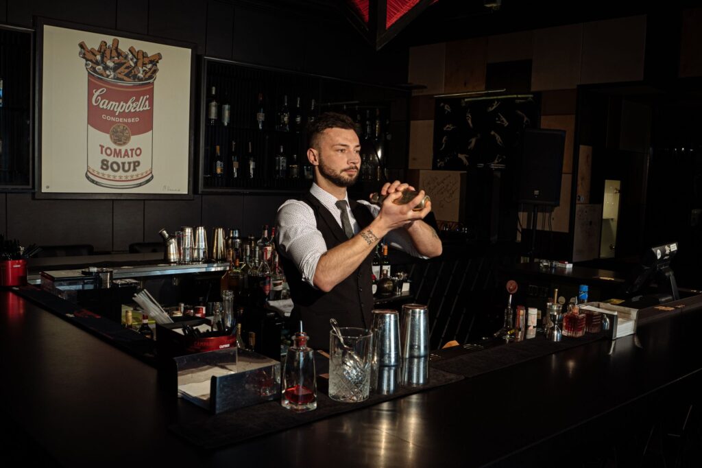 A bartender mixing a signature cocktail at a trendy Las Vegas bar. — Las Vegas nightlife bars clubs