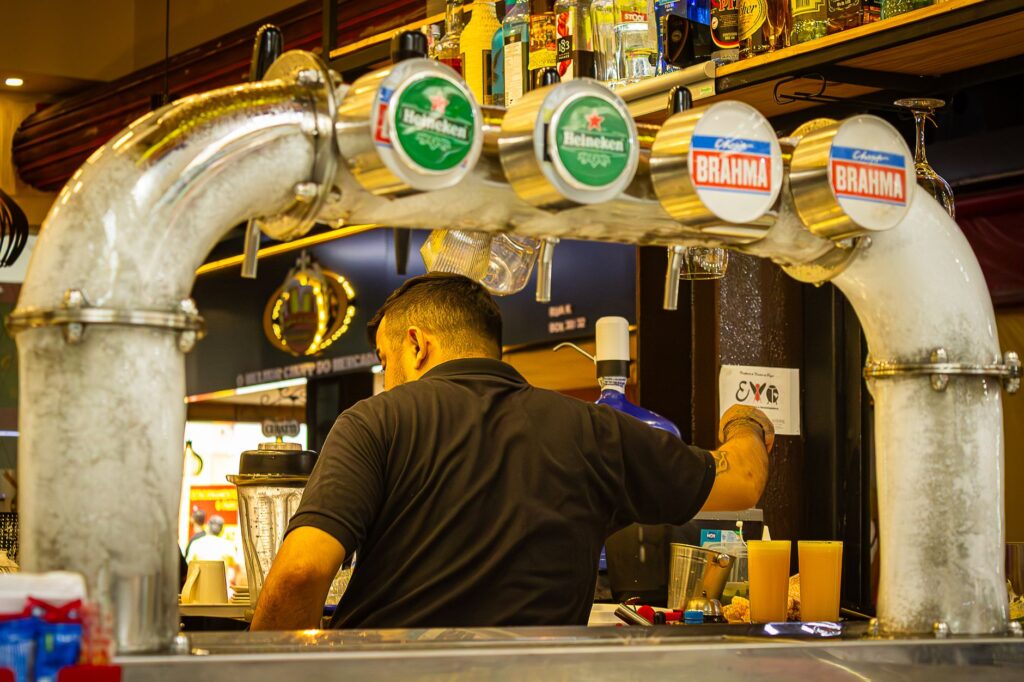 A bartender serving drinks at a busy Las Vegas casino bar. — free drinks Las Vegas gambling