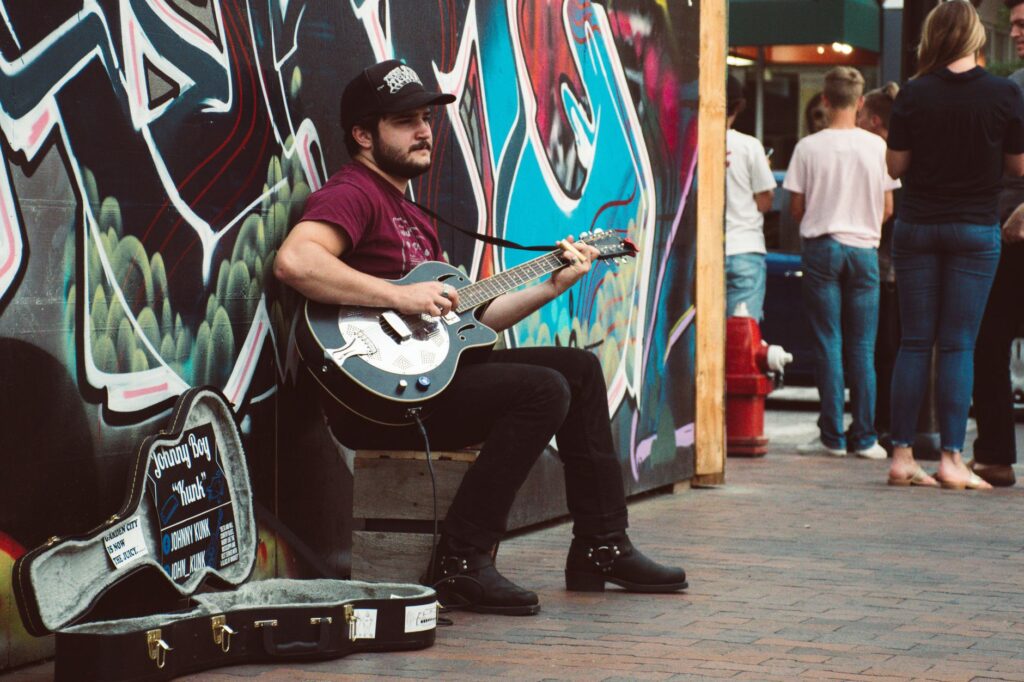 A bustling scene from Fremont Street Experience, filled with street performers and live music. — Las Vegas attractions f…