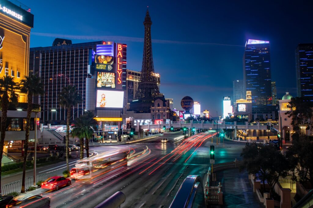 A busy Las Vegas Strip showcasing various transportation options like buses and taxis. — transportation in Las Vegas