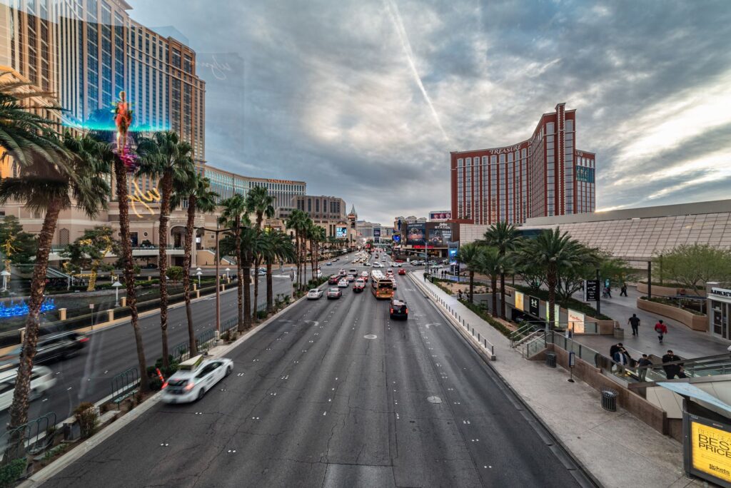 A busy Las Vegas Strip with various transportation options visible, including buses and taxis. — Las Vegas transportation