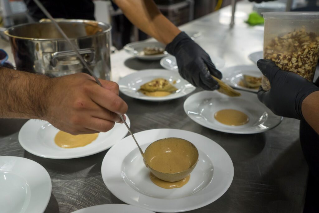 A chef in action at a new restaurant, illustrating the culinary creativity behind the latest dining trends. — new restau…