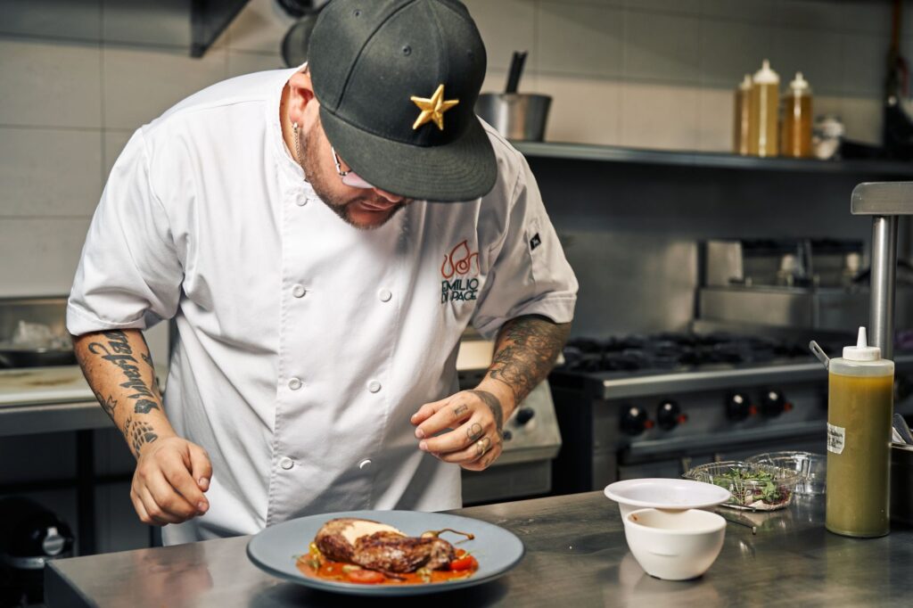 A chef preparing a meal in an open kitchen at a high-end restaurant related to the best restaurants in Las Vegas 2026