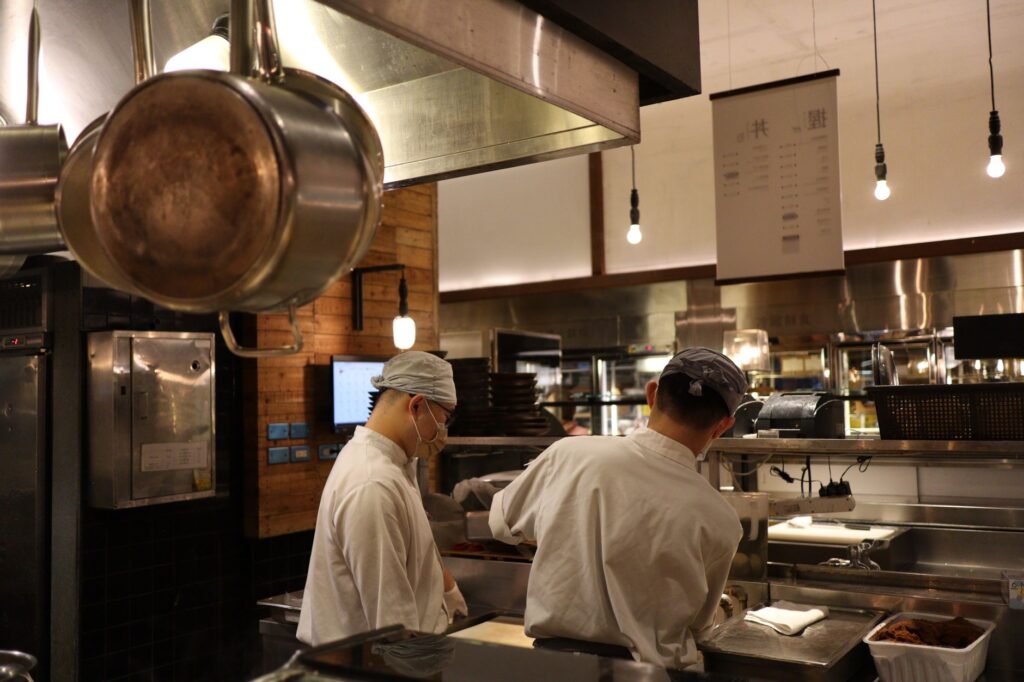 A chef preparing a meal in an open kitchen at a popular restaurant. — best restaurants in Las Vegas