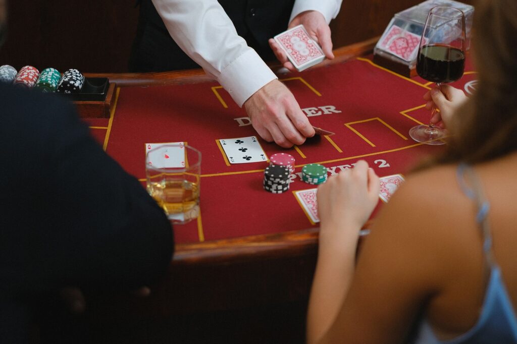 A close-up of a drink being served at a Vegas casino table. — free drinks gambling Vegas