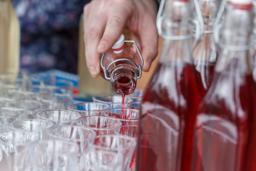 A close-up of drinks being served at a bar in a Las Vegas pool party setting. — Las Vegas pool parties
