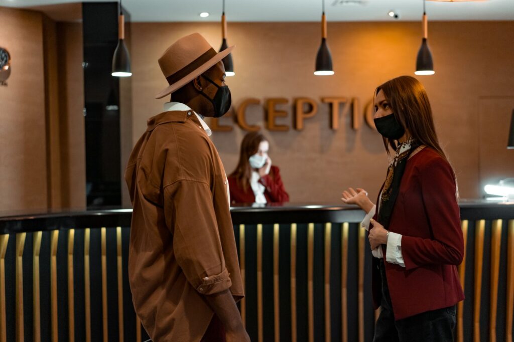 A couple checking into an affordable hotel with welcoming staff — affordable hotels in Las Vegas