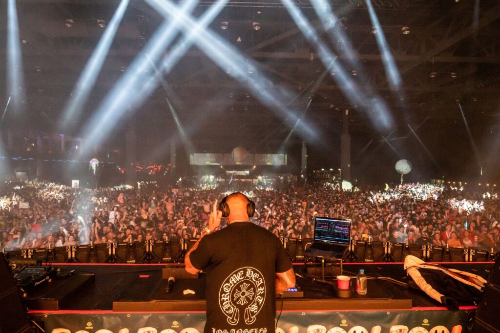 A famous DJ performing at one of the best clubs in Vegas, surrounded by an excited crowd. — Las Vegas nightlife