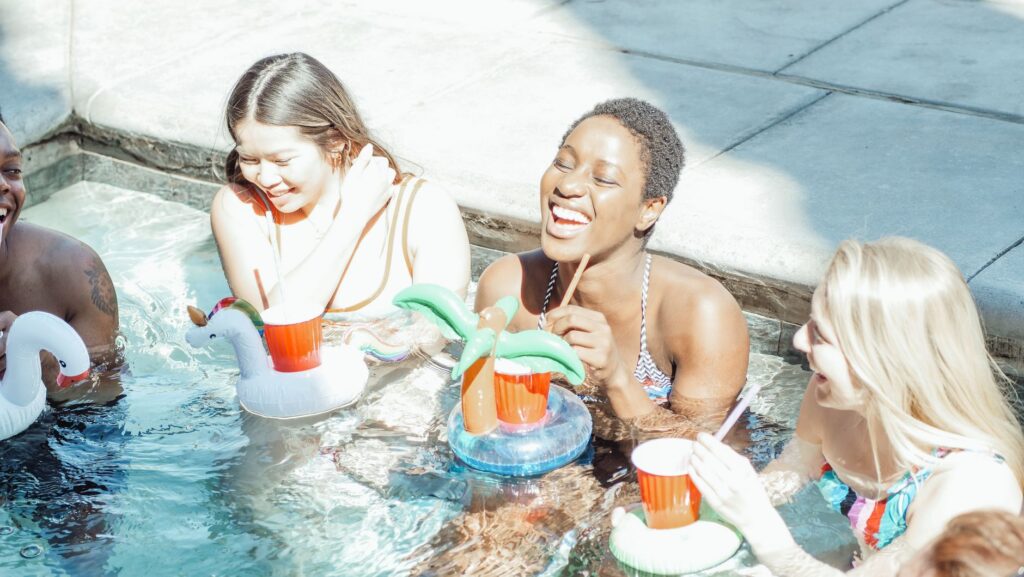 A group of friends enjoying cocktails by the pool, with the Las Vegas Strip in the background. — Las Vegas pool parties …
