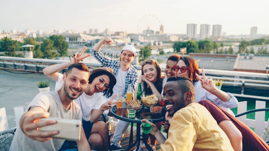 A group of friends enjoying drinks at a rooftop bar overlooking the Las Vegas Strip. — best nightlife Las Vegas 2026