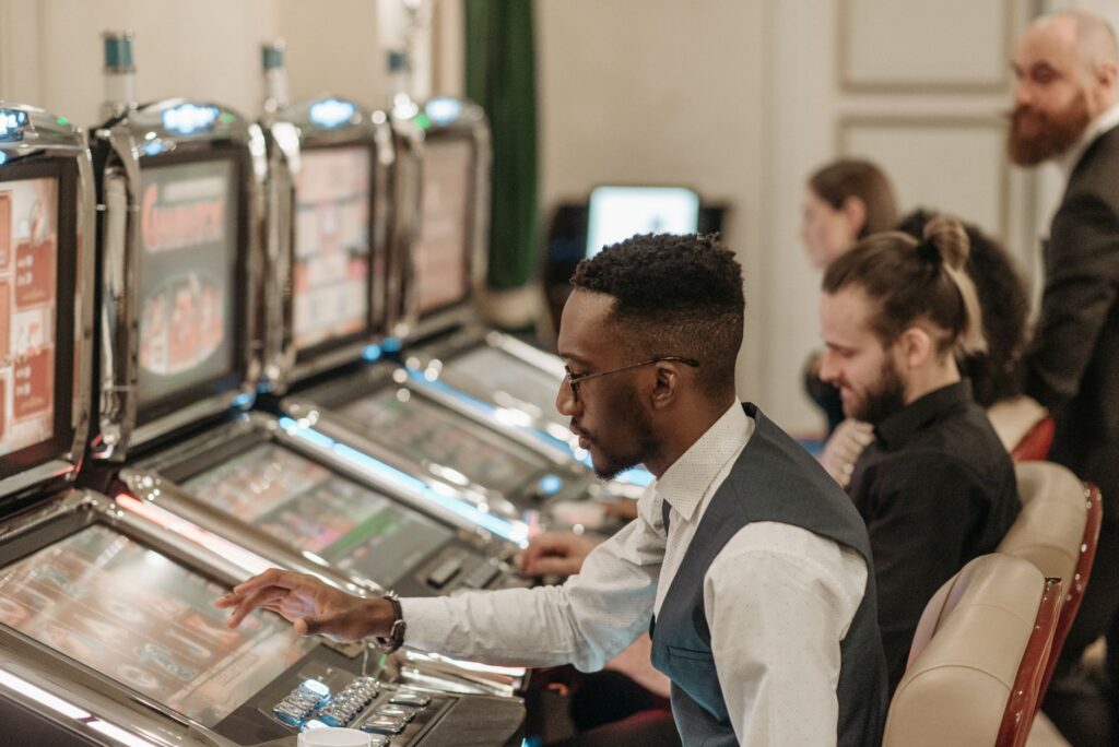 A group of friends enjoying drinks while playing slot machines — free drinks in Las Vegas casinos