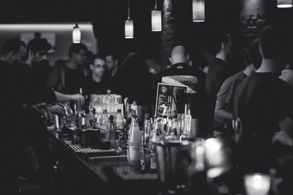 A lively bar scene with patrons socializing and live music in the background. — best nightlife in Las Vegas
