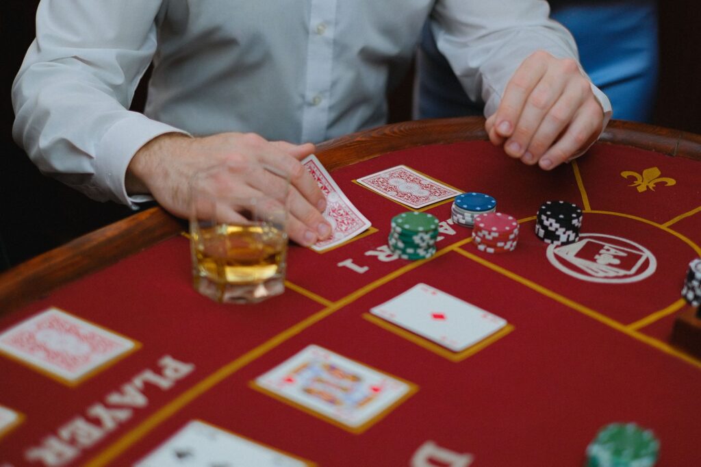 A player at a blackjack table with drinks in front of them. — free drinks Las Vegas gambling