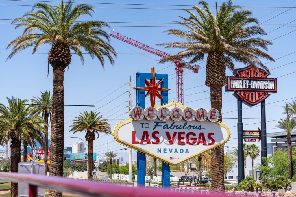 A sunny summer day at the Las Vegas Strip with tourists enjoying the attractions. — best time to visit Las Vegas