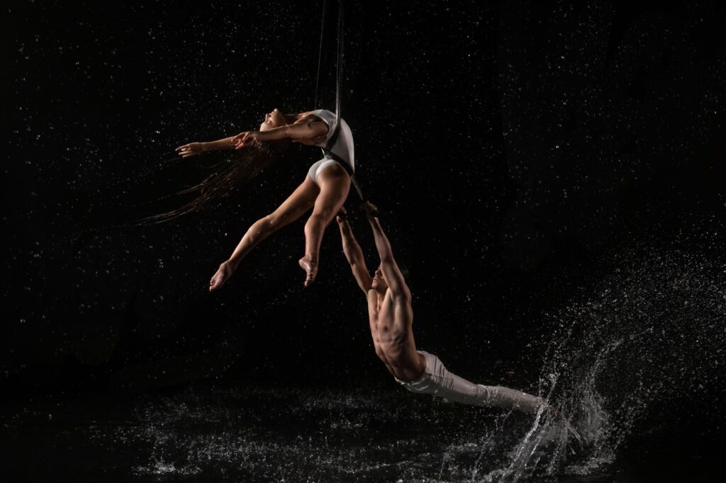 A vibrant photo of the Cirque du Soleil: O performance showcasing water acrobatics. — Las Vegas shows 2026