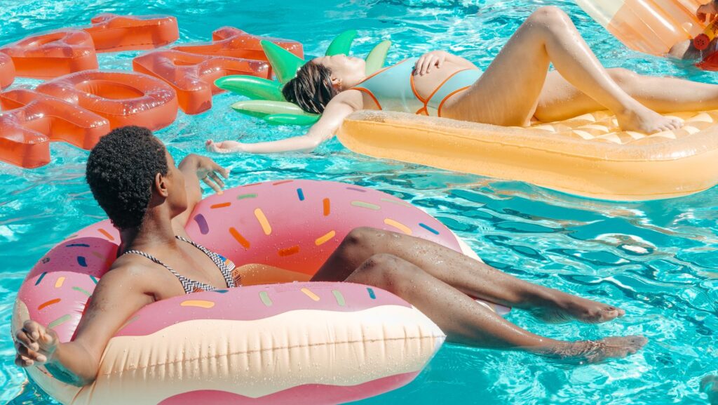 A vibrant scene of a packed Las Vegas pool party with guests enjoying cocktails and sunbathing. — Las Vegas pool parties