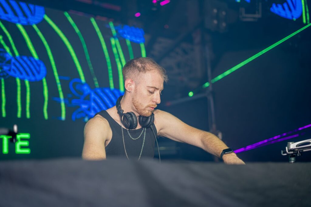 A vibrant shot of a DJ performing at a Las Vegas nightclub, showcasing the energetic atmosphere. — Las Vegas nightlife g…