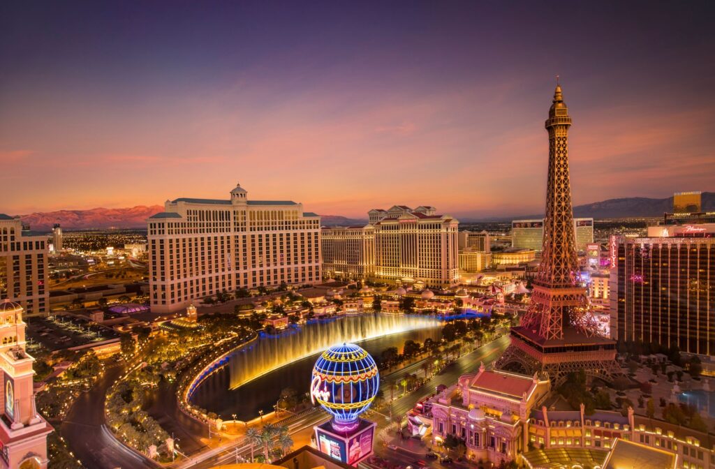 A vibrant view of the Las Vegas Strip during a summer sunset. — best time to visit Las Vegas